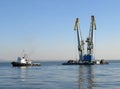 Large maritime cranes towed by boat Royalty Free Stock Photo