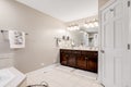 A large master bathroom with a dark vanity.