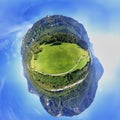 Large meadow area at the edge of the Alps behind a country road, Little Planet, Spherical 360 degrees seamless panorama view in