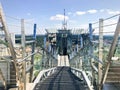 Large metal chrome shiny stairs with railings on the roof of a glass skyscraper, a tall building with a panoramic view of city Royalty Free Stock Photo