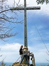 A large metal cross-crucifix on the top of Vitzauerstock or Gersauerstock on Rigi Mountain