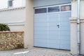 Large metal garage doors. Modern automatic garage door. Closed roller gates. Safe storage of the car