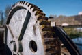 Large metal gear on a water sluice