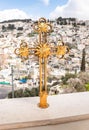 A large metal gilded cross stands on the balcony of the Greek Akeldama Monastery in the old city of Jerusalem in Israel