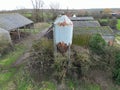 Large, metal grain feed silo showing a  poor state of repair. Royalty Free Stock Photo