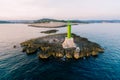 A large metal green lighthouse on a rock in the sea, near Cape Punta Planka in Croatia. Royalty Free Stock Photo
