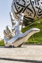 Large metal hand showing V - Victory near the Museum of The Future in Dubai city, United Arab Emirates