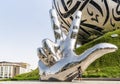 Large metal hand showing V - Victory near the Museum of The Future in Dubai city, United Arab Emirates