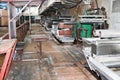 Large metal rollers rolls with teeth of the gears of the production line, a conveyor belt in the workshop at a industrial chemical Royalty Free Stock Photo