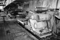 Large metal rollers rolls with teeth of the gears of the production line, a conveyor belt in the workshop at a industrial chemical