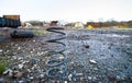 A large metal spring sits on the ground