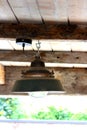Large metallic bulb hanging from a wooden ceiling