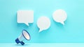 A large microphone is placed in front of three speech bubbles Royalty Free Stock Photo