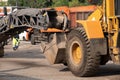 Large milling machine removing an old pavement layers at full depth