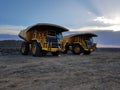 Large mine mining earth moving trucks construction twilight