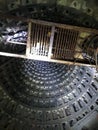 A large mine of a sewer collector that goes up with a rusty ladder