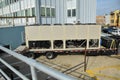 Large mobile air conditioning units on a trailer near a large apartment building Royalty Free Stock Photo