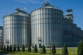 A large modern agro-processing plant for the storage and processing of grain crops. Fragment of large metal barrels of grain.