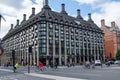 A large modern building in central London, cyclist commuting. Uk