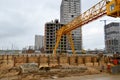 A large modern construction site in the construction of buildings and houses with appliances and many large high tower Royalty Free Stock Photo