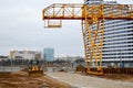 A large modern construction site in the construction of buildings and houses with appliances and many large high tower Royalty Free Stock Photo