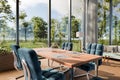 large modern contemporary loft with couch and dining table and indoor plants vertical garden panoramic view rural landscape Royalty Free Stock Photo