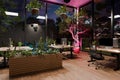 large modern contemporary office with pc workspaces and indoor plants vertical garden panoramic view rural landscape