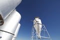 Large modern farm grain silos with blue sky