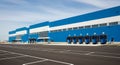 Modern Blue and White Warehouse Building with Loading Docks and Asphalt Parking Lot industrial architecture Royalty Free Stock Photo