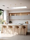 Large, modern kitchen with an island in center. There are four bar stools placed around island