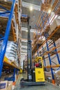 Large modern LADA-IMAGE warehouse with forklifts for storage vehicle spare parts.