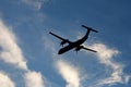 A large modern plane flies in the sky, a view from below from the ground to the belly of the aircraft.