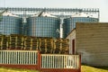 A large modern plant for the storage and processing of grain crops. A stack of wooden pallets. An outdoor pallet storage area. Royalty Free Stock Photo