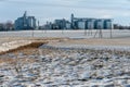 A large modern plant for the storage and processing of grain crops. view of the granary on a frosty sunny day. Silver silo grain Royalty Free Stock Photo