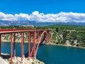 Large modern red metal bridge crosses the Adriatic sea in Maslenica, Croatia. Royalty Free Stock Photo