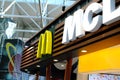 Large modern signboard, McDonald`s logo in lobby of airport, beautiful geometric background, three-dimensional letters, concept