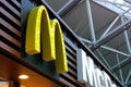 large modern signboard, McDonald\'s logo in lobby of airport, beautiful geometric background, three-dimensional letters