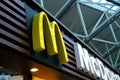 large modern signboard, McDonald\'s logo in lobby of airport, beautiful geometric background, three-dimensional letters