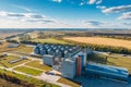 Large modern silos granary steel tanks or containers for silos, wheat and other cereals. Industrial agriculture, aerial view