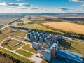 Large modern silos granary steel tanks or containers for silos, wheat and other cereals. Industrial agriculture, aerial view