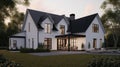 Large modern two-storey country house in European Scandinavian style with white walls and black roof. A neatly trimmed Royalty Free Stock Photo