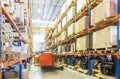 Large modern warehouse with moving forklifts Royalty Free Stock Photo