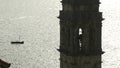 Large monuments standing next to the sea.Creative.A large stone tower and bell tower standing next to the sea with a Royalty Free Stock Photo