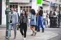 A large motley crowd walks up Bricklane on a Sunday afternoon. The flea market on Bricklane works on Sundays. Royalty Free Stock Photo