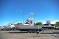 Large motor boats on car trailers parked at the pier