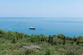 Large motor yacht on the shore of the calm blue sea.