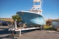 large motorboat on a car trailer is parked at the pier Royalty Free Stock Photo