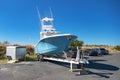 large motorboat on a car trailer is parked at the pier Royalty Free Stock Photo