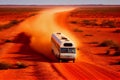 Large motorhome bus driving in the arid Australian outback. Red dirt road. Lap of Australia Royalty Free Stock Photo