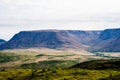 Large mountain plateau and valley under cloudy sky